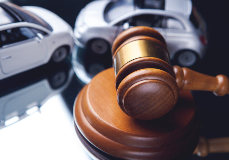 Model of car and gavel. Accident lawsuit or insurance, court case.